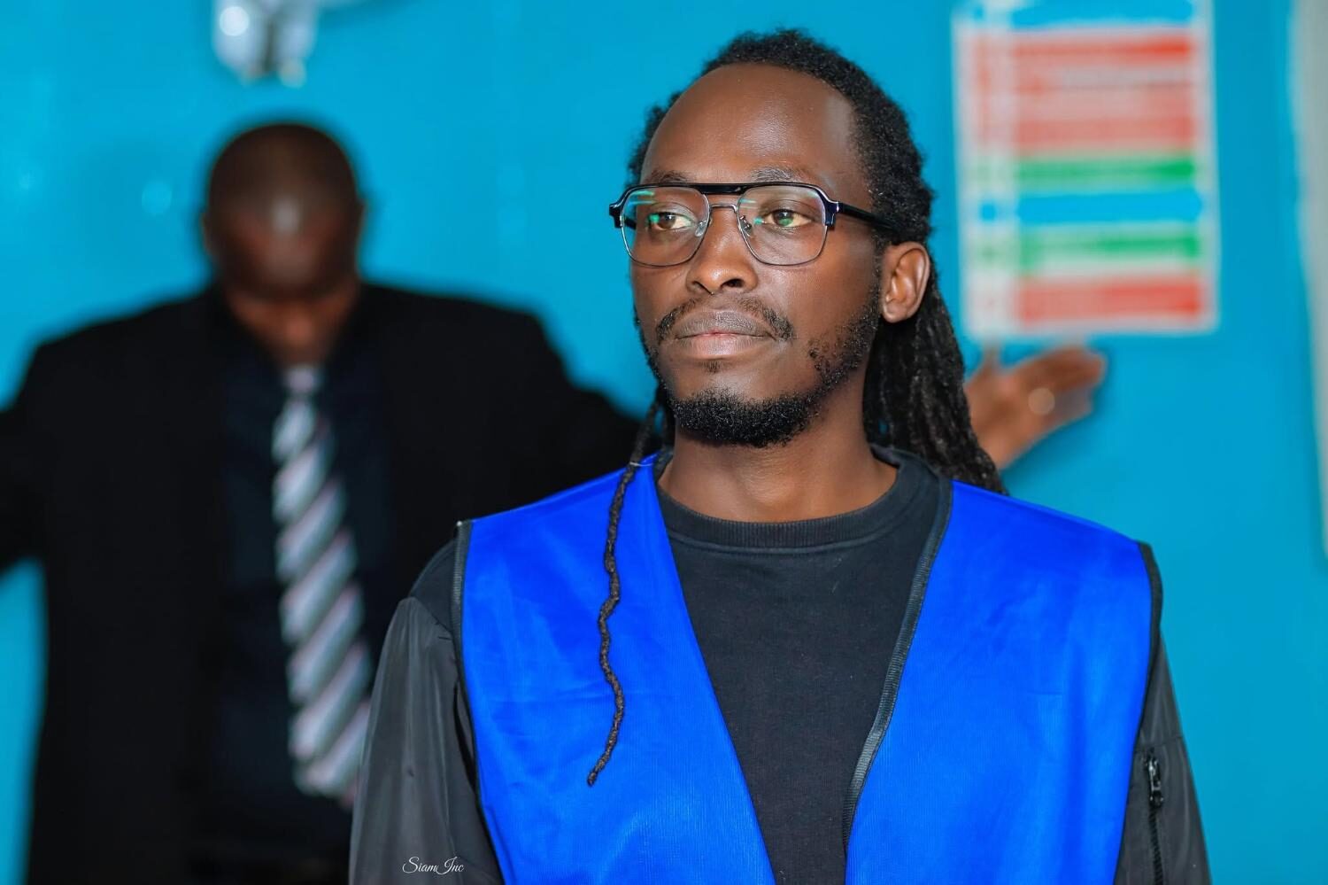 Young man in blue vest during church service