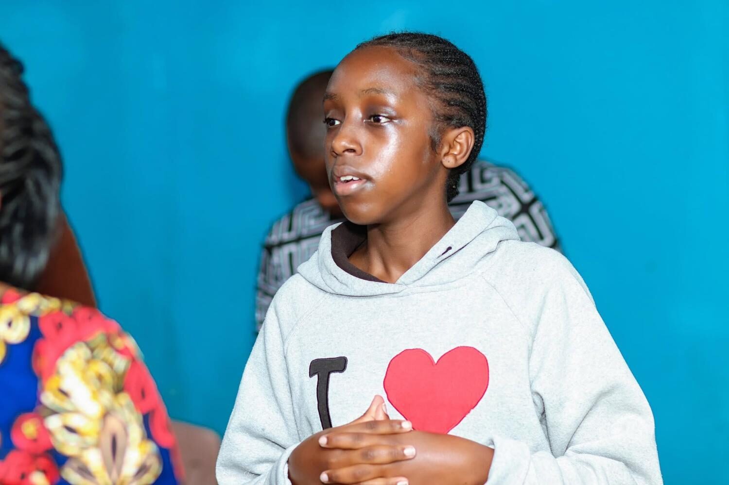 Young girl in grey hoodie at church