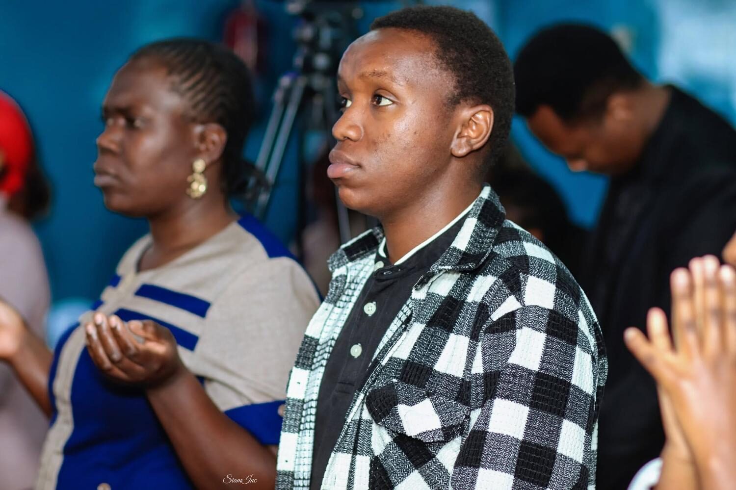 Young man in congregation during worship